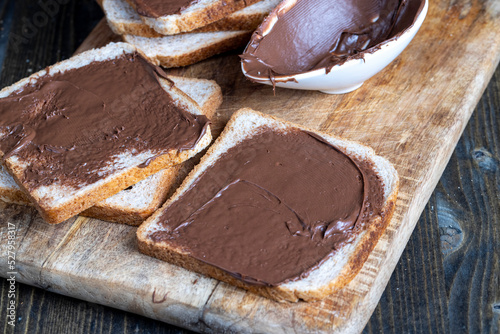 Chocolate butter spread on bread while cooking breakfast