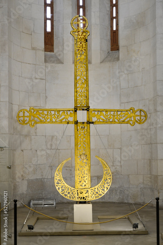 An ancient gilded cross from the dome of the 12th century Dmitrievsky Cathedral in Vladimir, Russia photo