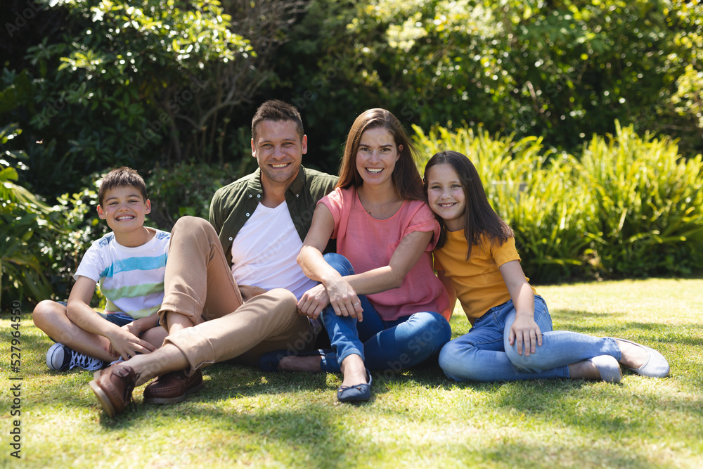 Portrait of caucasian family spending time in their garden together Portrait of caucasian family spending time in their garden together