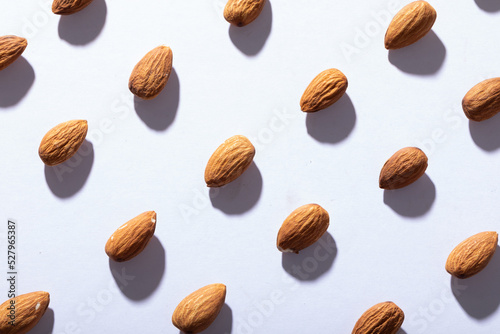 Full frame shot of almonds arranged on white background with copy space
