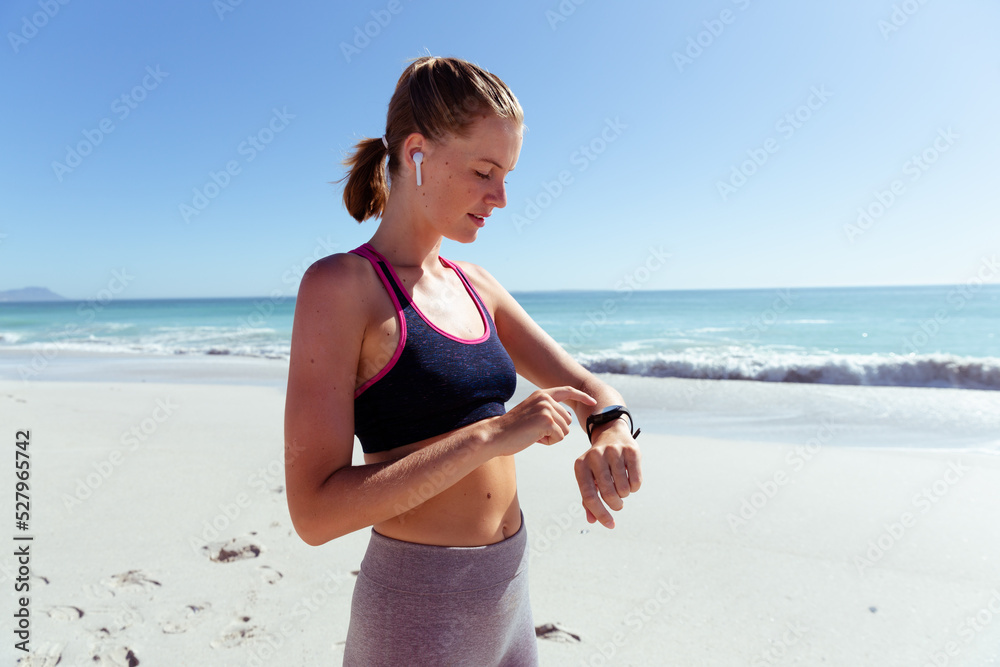 Fototapeta premium Caucasian woman exercising seaside