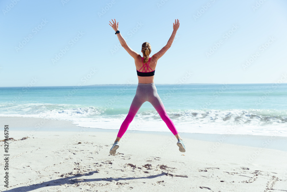 Caucasian woman exercising seaside Caucasian woman exercising seaside