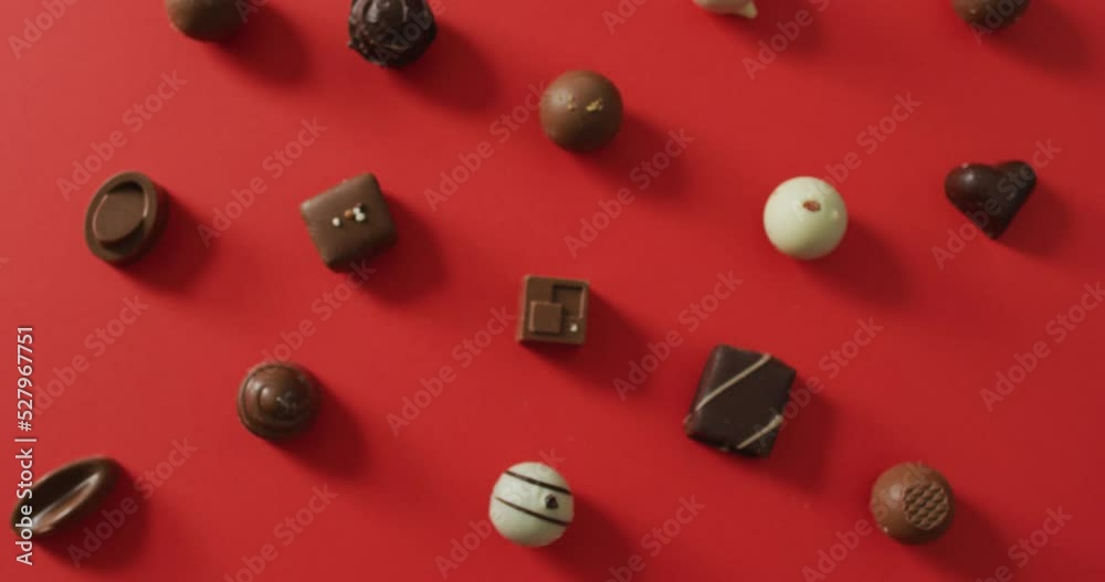 Black and white chocolates on red background at valentine's day Black and white chocolates on red background at valentine's day