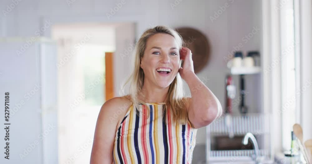 Portrait of happy caucasian mature woman smiling in the kitchen Portrait of happy caucasian mature woman smiling in the kitchen