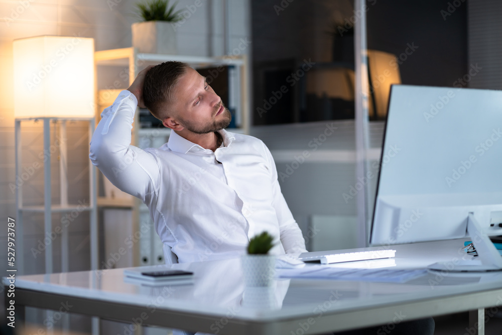 Man Stretching At Office Desk Man Stretching At Office Desk