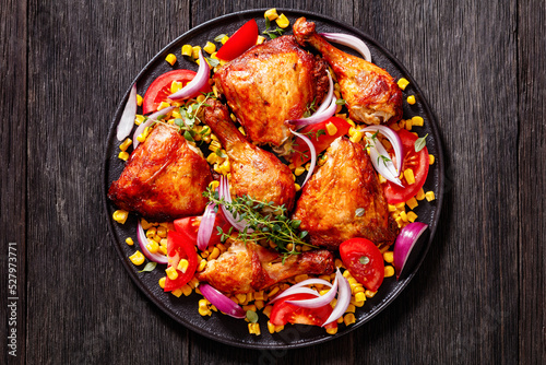 roast chicken with corn and tomatoes on plate