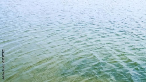 Small waves on the surface of the water. Ripples on the lake, sea, ocean.