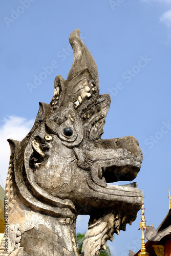 Lion statue in Wat Phra Sing Waramahavihan temple isolated blue sky.