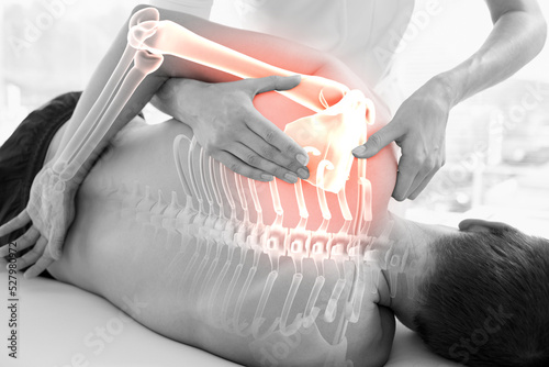 Highlighted joints and spines of injured man having massage 