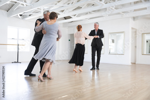 Caucasian senior couples ballroom dancing photo