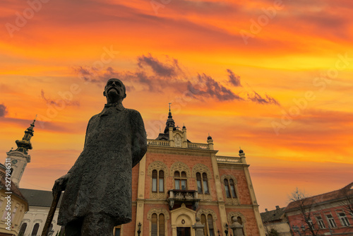 Novi Sad square, novi sad church and municipality building with sunset clouds and colors photo