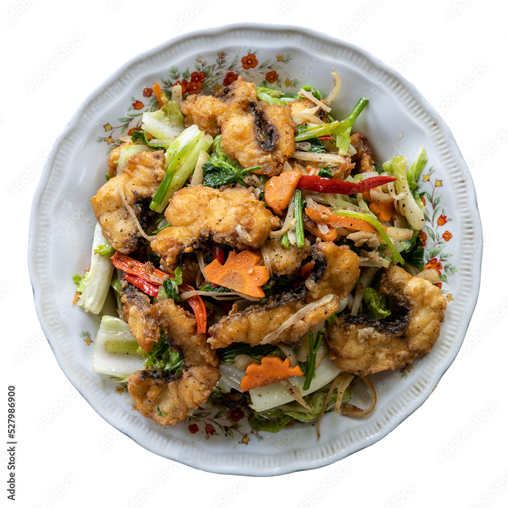 Isolate, top view, close-up, stir-fried fish with delicious vegetables in a dish, a popular local dish in rural Thailand. Isolate, top view, close-up, stir-fried fish with delicious vegetables in a dish, a popular local dish in rural Thailand.