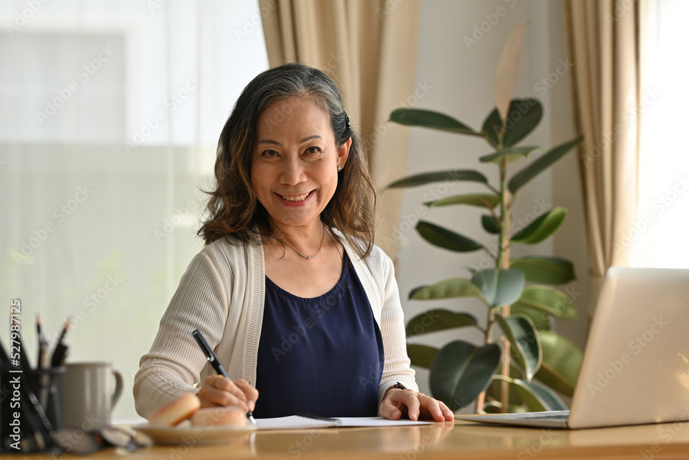Happy Senior old woman working with her laptop at home, Stay at home, Work from home concept. Happy Senior old woman working with her laptop at home, Stay at home, Work from home concept.