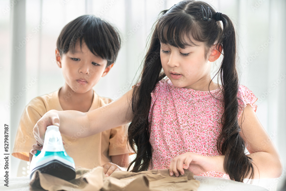 young happy boy and girl iron school uniform for education at home during weekend house cleaning family activity young happy boy and girl iron school uniform for education at home during weekend house cleaning family activity