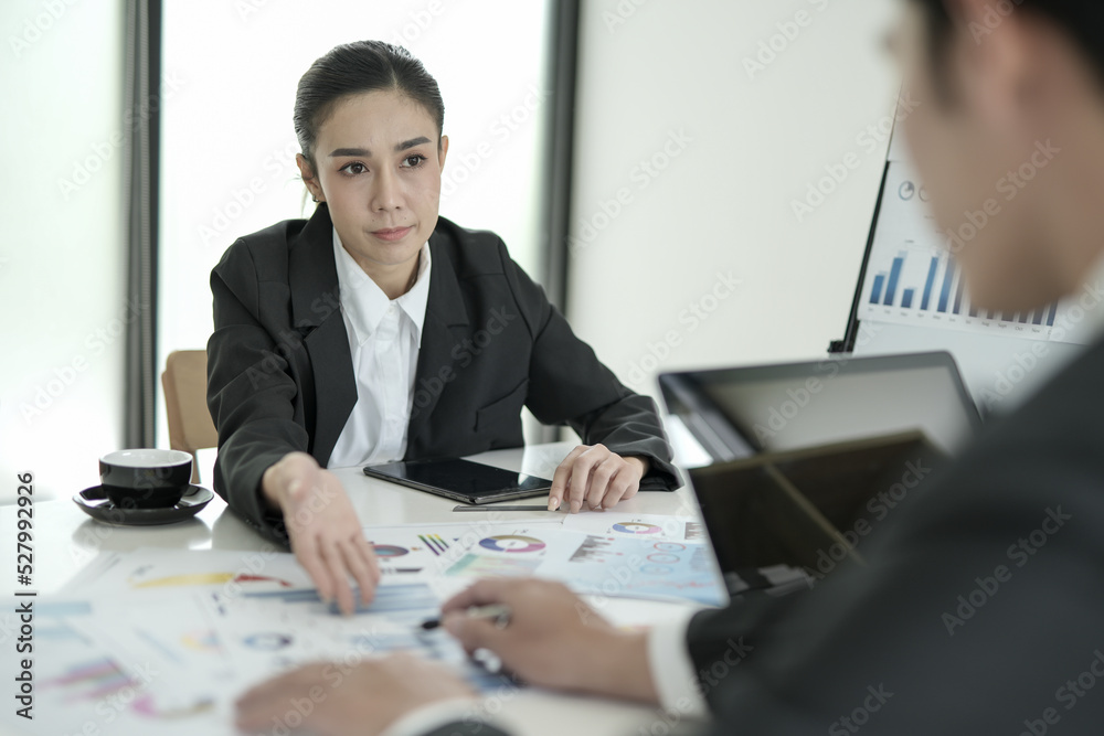Asian businesswoman planning work in conference room with team Asian businesswoman planning work in conference room with team