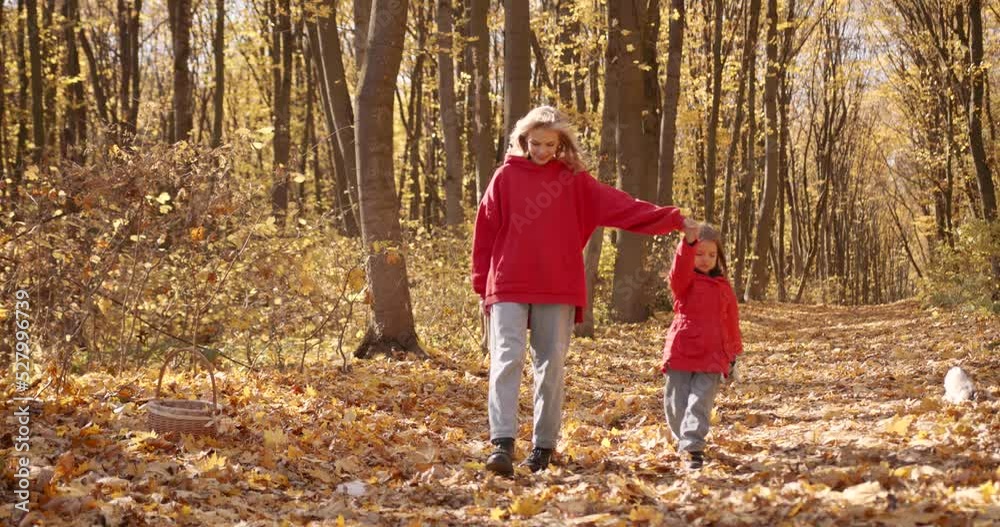 Young blond mother with her daughter walking in park Young blond mother with her daughter walking in park
