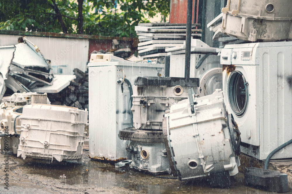 Broken White Washing Machines whole and detail parts on the street under rain fall Broken White Washing Machines whole and detail parts on the street under rain fall