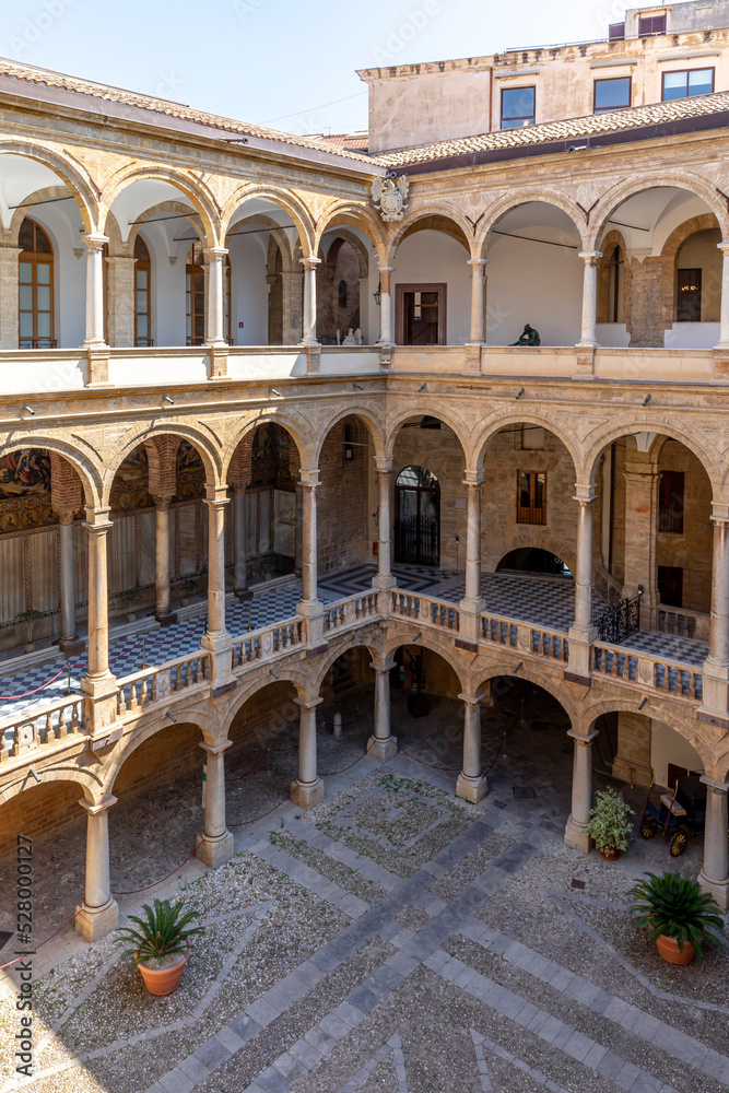 Palermo, Italy - July 6, 2020: Courtyard of Palazzo dei Normanni (Palace of the Normans, Palazzo Reale) in Palermo city. Royal Palace was the seat of the Kings of Sicily during the Norman domination