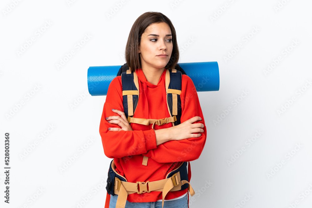 Young caucasian mountaineer girl with a big backpack isolated on white background thinking an idea Young caucasian mountaineer girl with a big backpack isolated on white background thinking an idea