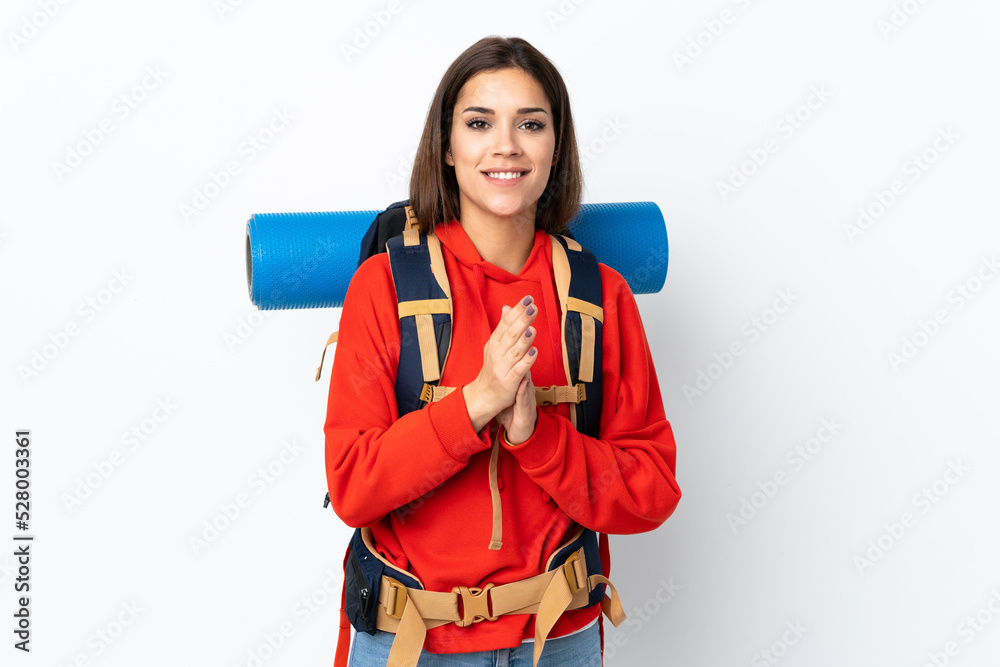 Young caucasian mountaineer girl with a big backpack isolated on white background applauding Young caucasian mountaineer girl with a big backpack isolated on white background applauding