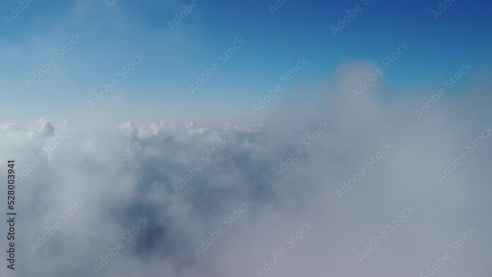Aerial view. The drone flies over foggy and fluffy clouds. Blue sky sun and sea fog. Abstract aerial nature summer ocean sunset sea and sky background. Vacation, vacation and holiday concept Aerial view. The drone flies over foggy and fluffy clouds. Blue sky sun and sea fog. Abstract aerial nature summer ocean sunset sea and sky background. Vacation, vacation and holiday concept