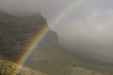 Rainbow and Tirajana cliffs in the fog. Cliffs of Tirajana Natural Monument. San Bartolome de Tirajana. Gran Canaria. Canary Islands. Spain.
