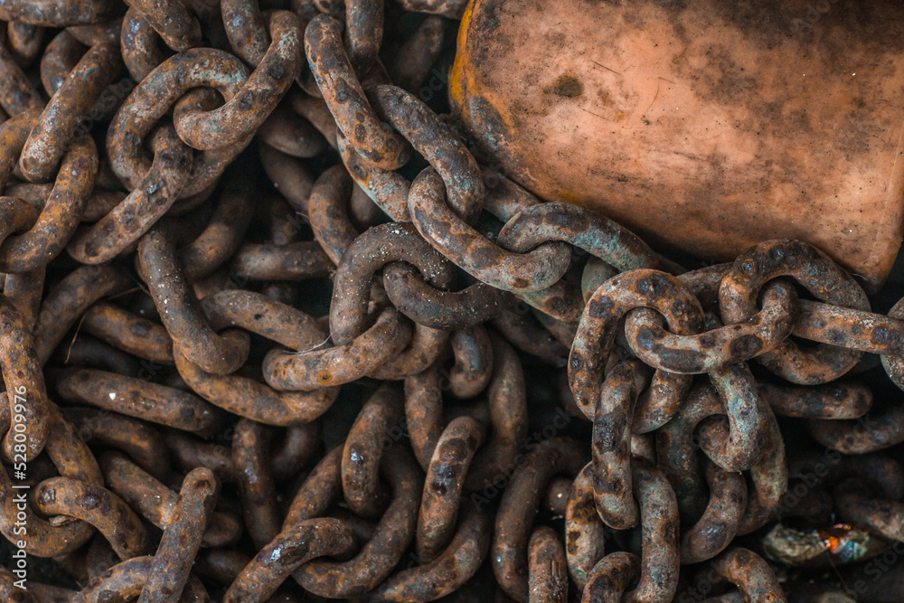 Rusty Iron anchor ship chains caked with dust at old coast ship. Rustic iron chains background. Rusty Iron anchor ship chains caked with dust at old coast ship. Rustic iron chains background.
