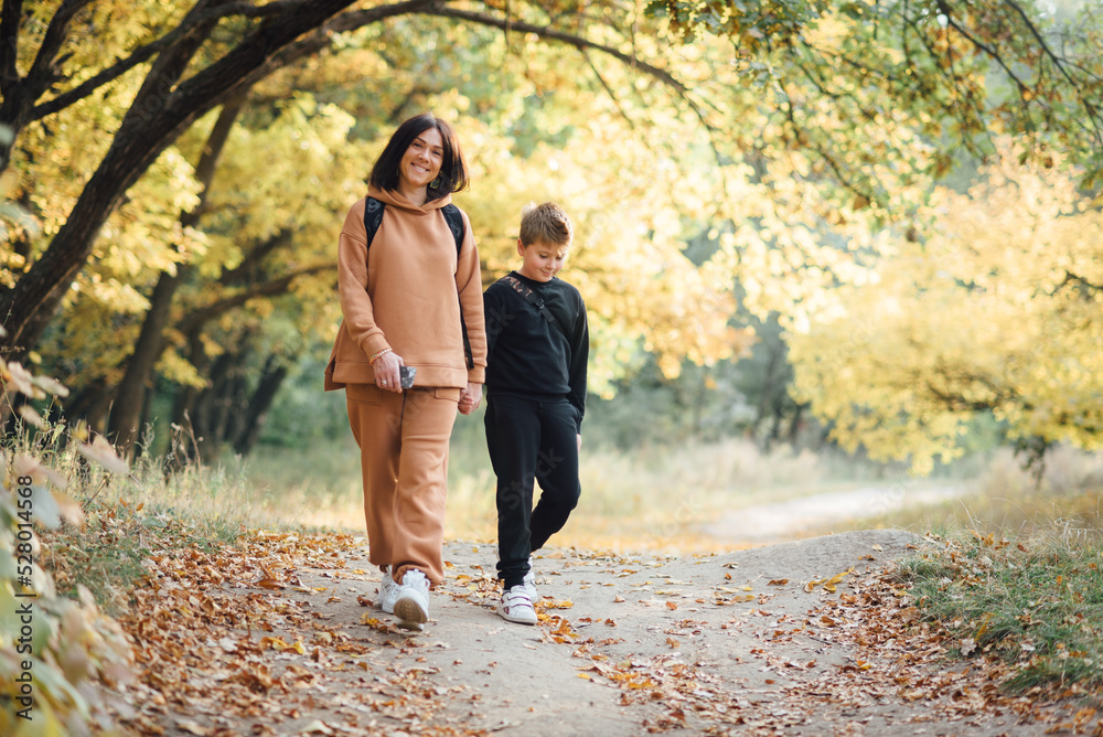 Fototapeta premium Mother and son walking during outdoor autumn walk