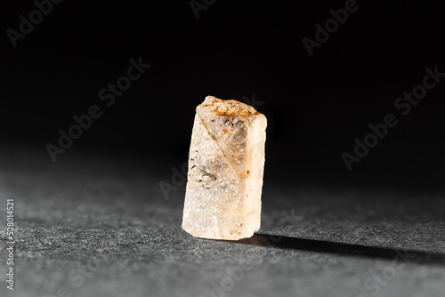 Rough uncut Yellow Topaz stone sample on black