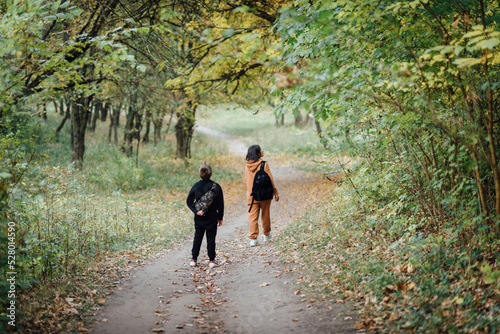 Mother and son walking and exploring nature during outdoor autumn walk © Denys Poliakov