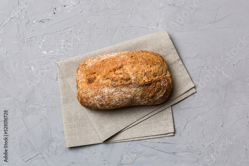 Fresh Homemade Whole Wheat Bread. bread on napkin on rustic background, fresh bread top view