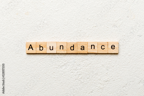 abundance word written on wood block. abundance text on table, concept photo