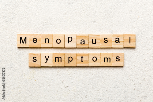 menopausal symptoms word written on wood block. menopausal symptoms text on cement table for your desing, concept