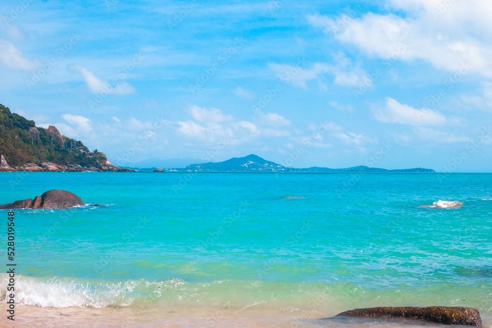 Sea bright landscape. Azure sea and stones in the water on a sunny day. Wallpaper, postcard, travel concept Sea bright landscape. Azure sea and stones in the water on a sunny day. Wallpaper, postcard, travel concept