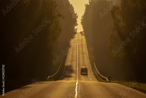 Beautiful road in the sunrise fog