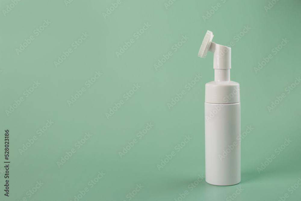face foam in a bottle, beauty skincare cosmetic on a natural green background face foam in a bottle, beauty skincare cosmetic on a natural green background