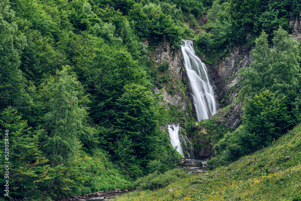 Picturesque waterfall on the mountains (Sauth deth Pish, Vall d'Aran, Spain)