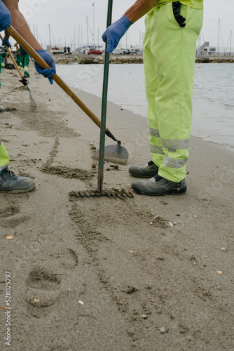 Crude oil spill in Gibraltar and the Andalusian coast. Unrecognizable workers cleaning the sand.