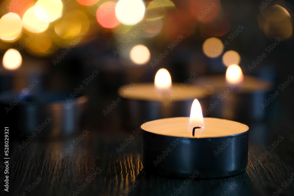 Candle light and bokeh background in the darkness with space for text or image.