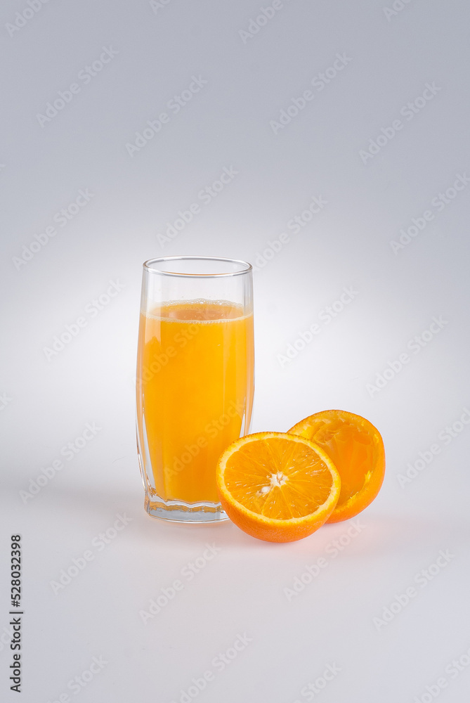 Glass of orange juice and peel from orange on a white background Glass of orange juice and peel from orange on a white background