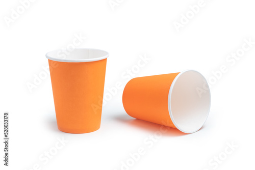 Two orange paper cups on an white background, take away coffee concept.