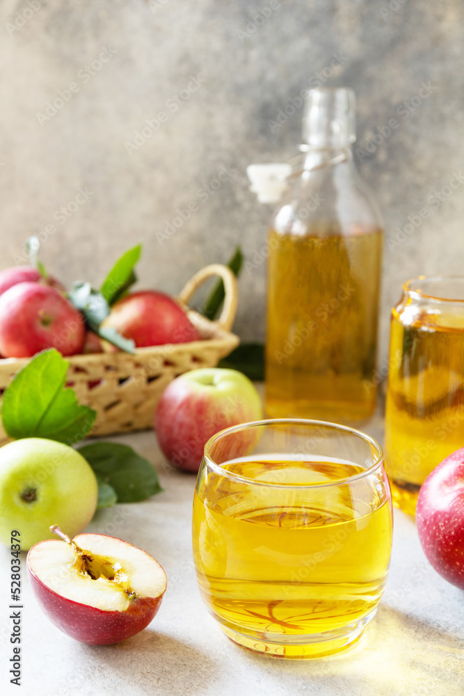 Autumn vitamin drink juice apple. Apple juice in a glass and fresh apples on a stone tabetop. Autumn vitamin drink juice apple. Apple juice in a glass and fresh apples on a stone tabetop.