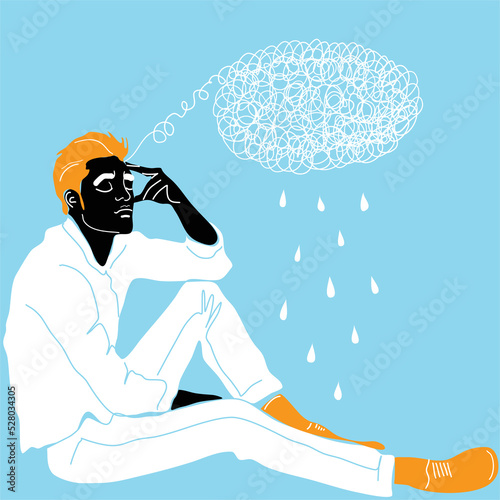 A young guy is sitting and holding his head with his hand meditating. Sadness, depression and thoughts. The concept of excitement, insecurity, mental illness, sadness and fatigue