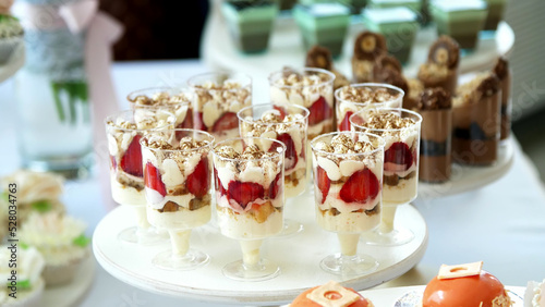 close-up  a variety of delicious desserts  cakes with cream  chocolate and strawberries. whipped cream with cinnamon. festive decor  a sweet bar  a corner  a treat. High quality photo