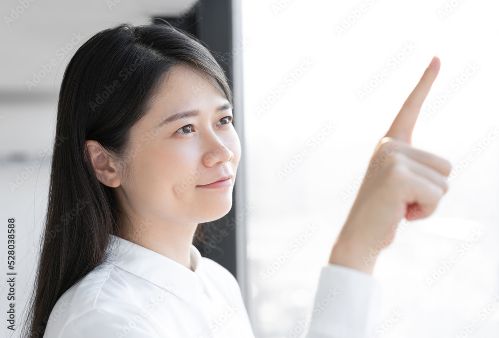 woman look at window and pointing on something woman look at window and pointing on something
