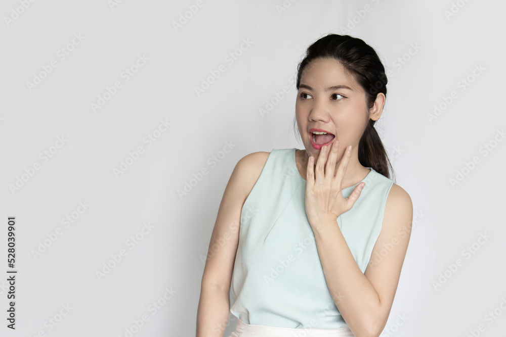Asian beautiful women raise hand touch her cheek and make puckering mouth with shocked and a surprised face when get good and bad news or information or promotion Asian beautiful women raise hand touch her cheek and make puckering mouth with shocked and a surprised face when get good and bad news or information or promotion