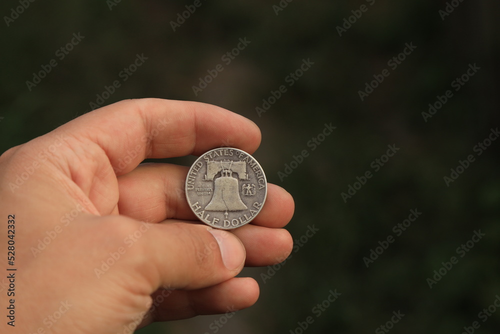 Old half dollar silver coin in hand Old half dollar silver coin in hand