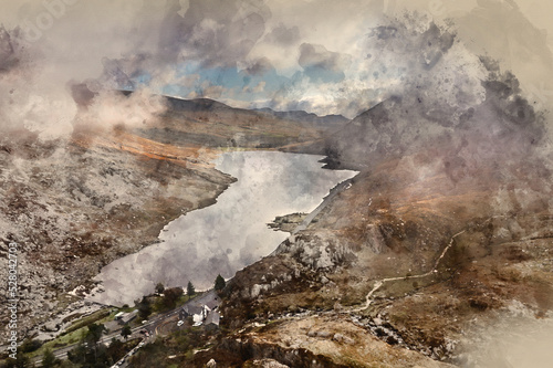 Digital watercolour painting of Aerial view of flying drone Epic Autumn Fall landscape image of view along Ogwen vslley in Snowdonia National Park with moody sky and mountains © veneratio