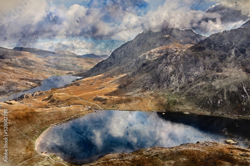 Digital watercolour painting of Aerial view of flying drone Epic Autumn Fall landscape image of view along Ogwen vslley in Snowdonia National Park with moody sky and mountains