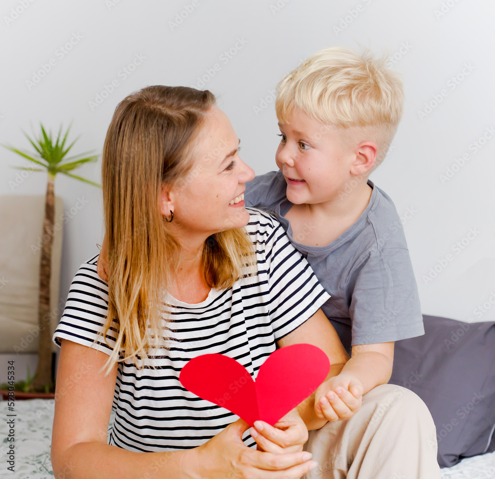 happy mother and son with handmade greeting card heart shape indoor ,mothers day background happy mother and son with handmade greeting card heart shape indoor ,mothers day background